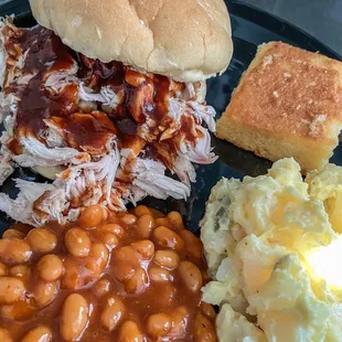 Take out spread. Chicken Sandwich, Baked Beans, Potato Salad, Cornbread