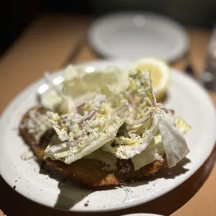 Pork milanese with cabbage, anchovies and horseradish