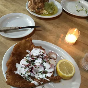 Pork Milanese and Pizza bianca with green tomatoes and ricotta