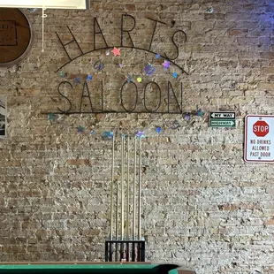 Signage on wall, near pool table.