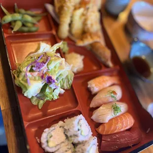 a tray of sushi and rolls