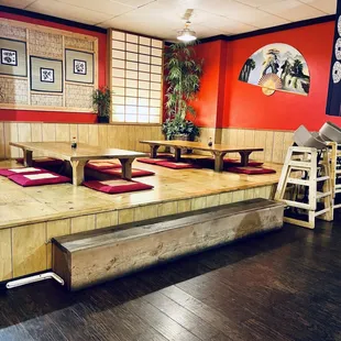 a japanese restaurant with wooden tables and red walls