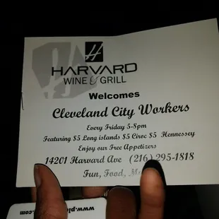 a hand holding a business card