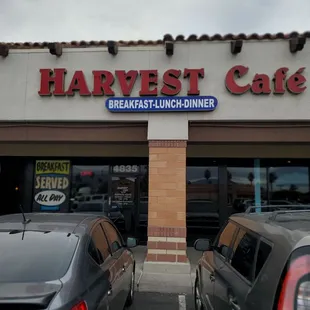 two cars parked in front of the restaurant