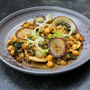 a plate of chickpeas, potatoes, and spinach