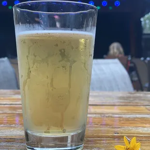 a glass of beer on a wooden table