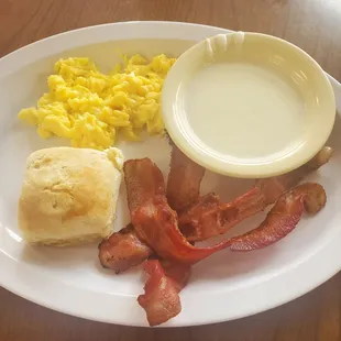 bacon, biscuits, and eggs on a plate
