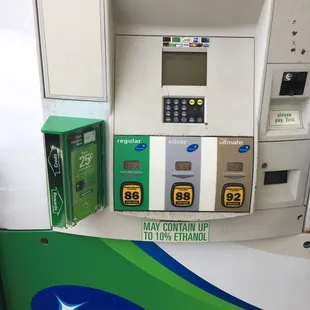 a gas pump with a green and white sign