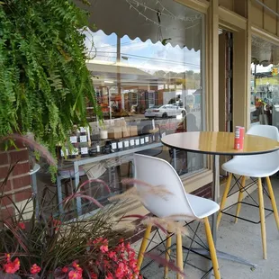 tables and chairs in front of a store