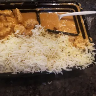 a meal of rice, chicken and gravy