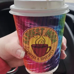 a hand holding a cup of coffee