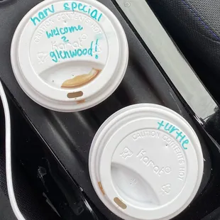 two cups of coffee in a cup holder