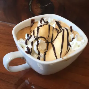 Affogato; espresso poured over ice cream with whipped cream and dark chocolate drizzle. Highly recommend!