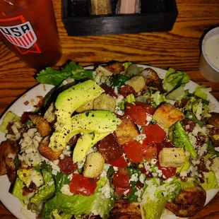Shrimp salad with blue cheese crumbles, house made curtons, bacon crumbles, lemon dressing on the side.