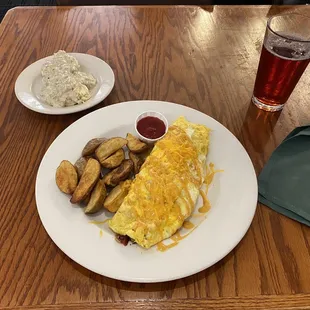 The Outback Omelette with fried potatoes and a biscuit with gravy