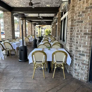 Outdoor seating on both sides of the entrance