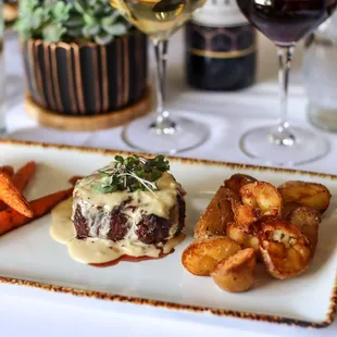 a plate of food and a glass of wine