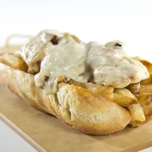a hot dog covered in cheese and onions