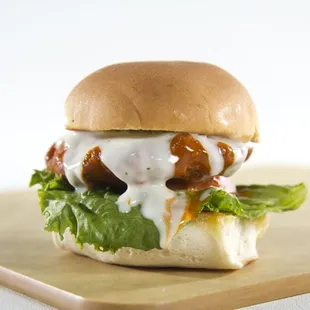 a burger with lettuce and sauce