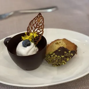 Espresso and dark chocolate pot de crème with mezcal whipped cream and madeleine