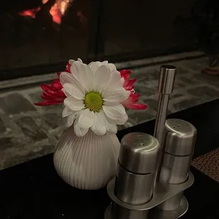Fireplace from table with fresh flowers