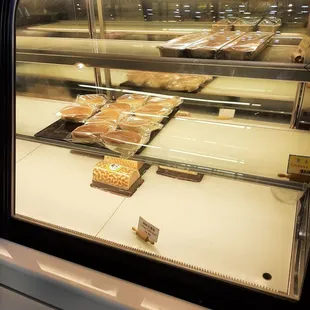a display case with a variety of baked goods