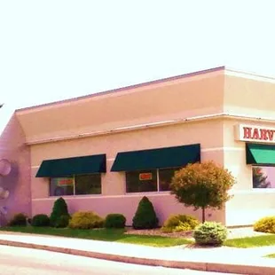 a blue van parked in front of the building
