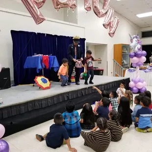 Stage show at Keehi Lagoon involving two young volunteers.  Dance off!