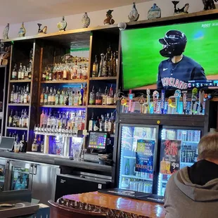 a man watching a baseball game on tv