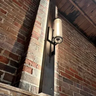 a brick wall with a lamp on it