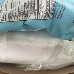 A full sandwich comes with chips and a pickle.