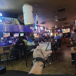 a person holding a beer