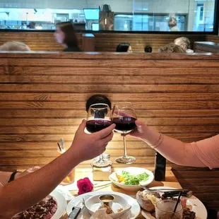 a man and a woman toasting at a restaurant