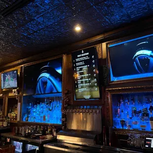 a bar with multiple televisions