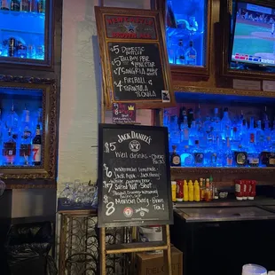 a bar with a chalkboard menu