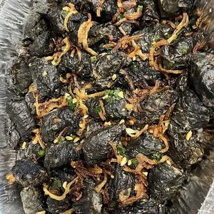 a bowl of dried black peppers