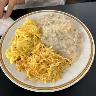 Biscuit and gravy, hashbrowns, and scrambled egg