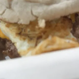 The famous 408 Smash Breakfast Sandwich: made with fresh egg,patty with onions,special sauce on English muffin with melted cheese