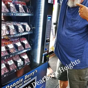 a man standing in front of a vending machine