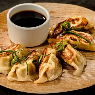 a plate of dumplings and a cup of coffee