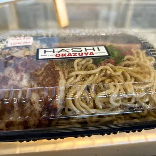 a plastic container with noodles