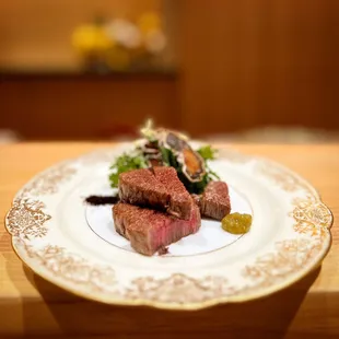 a close up of a piece of steak on a plate