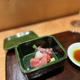 a bowl of hashiri with a side of sauce