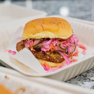 a chicken sandwich in a styrofoam container