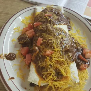 Breakfast burrito topped with chili.