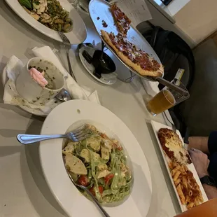 Pesto chicken (left), the Hasta (center), parmesan chicken (right), Classic pizza (far back center)