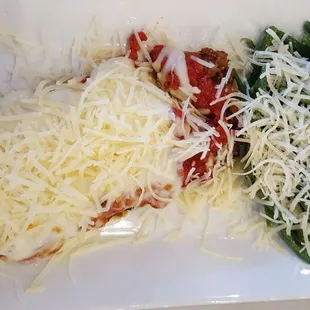 Eggplant Parmesan and Fresh Green Beans; Both topped with lots of fresh grated parmesan cheese.  My husband&apos;s lunch.