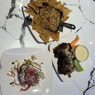 Skillet elote, mole wings, flautas
