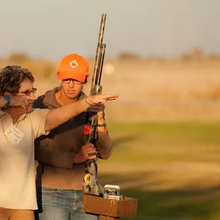 One of the Becoming An Outdoors Woman instructors gives a group of women tips on how to make the perfect shot.