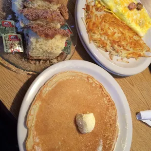 Pancakes the size of the plate. A meaty omelette with oozing cheese. Yummy hash browns and scrumptious coffee cake.